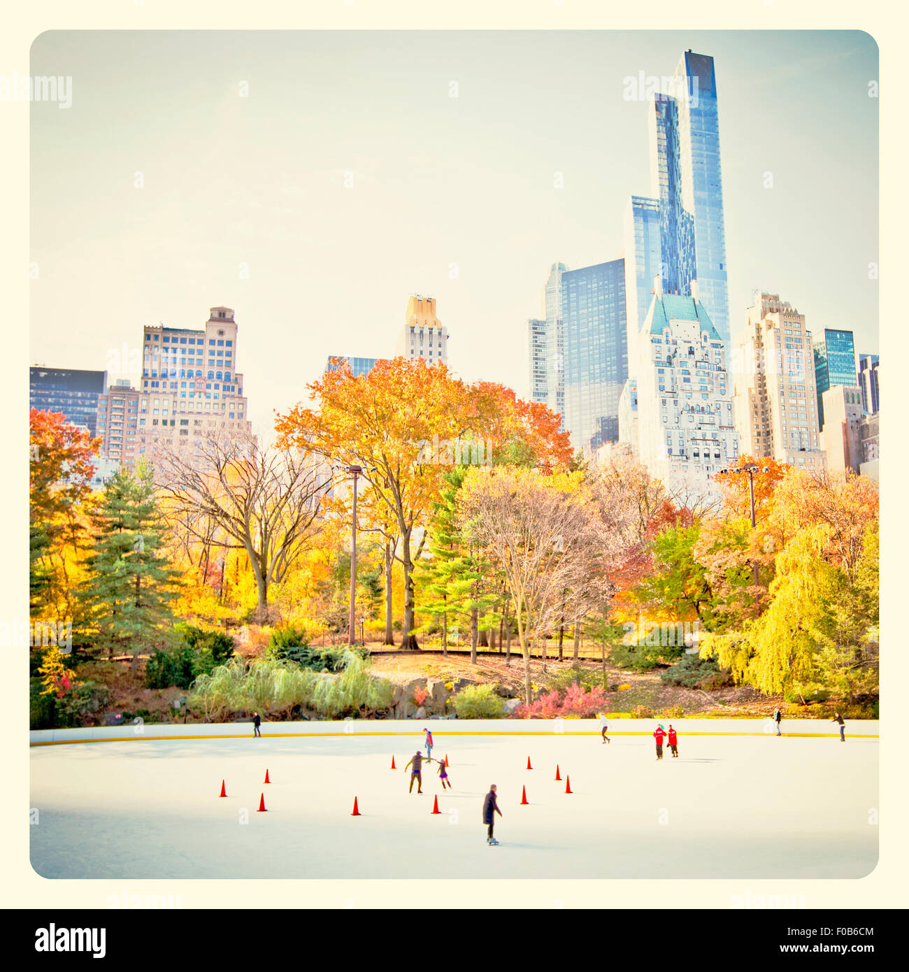 Ice skaters having fun in New York Central Park in fall with Instagram style filter Stock Photo