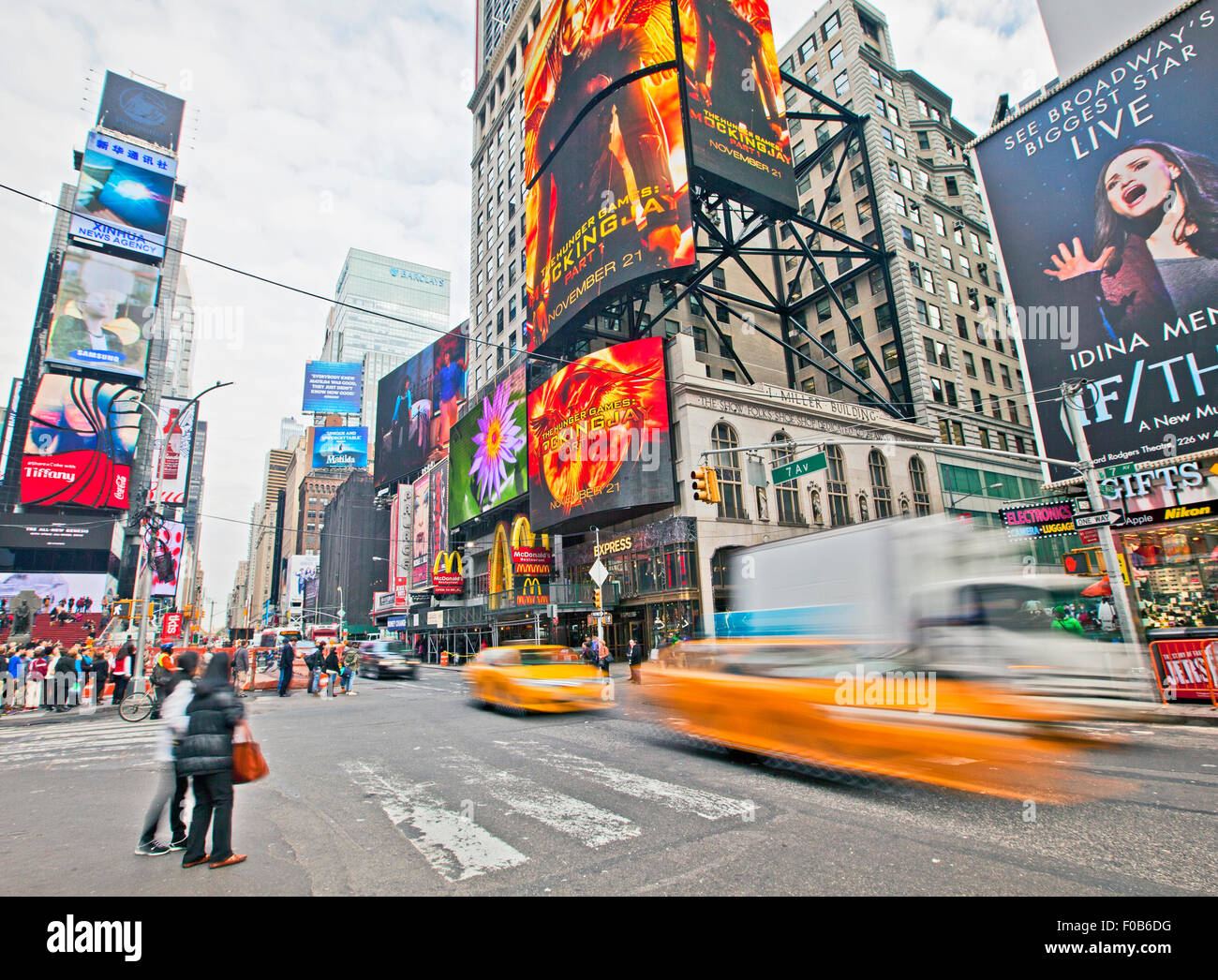 NEW YORK, USA - NOVEMBER 13th, 2014: Traffic driving through New York's famous Times Square area with colorful signage. Stock Photo
