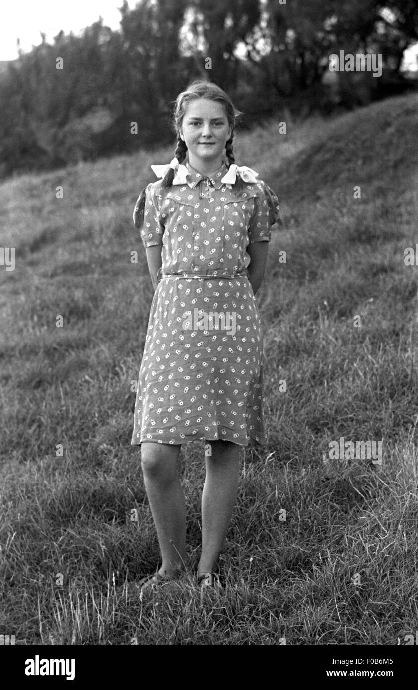 A girl wearing a dress standing in a field Stock Photo - Alamy