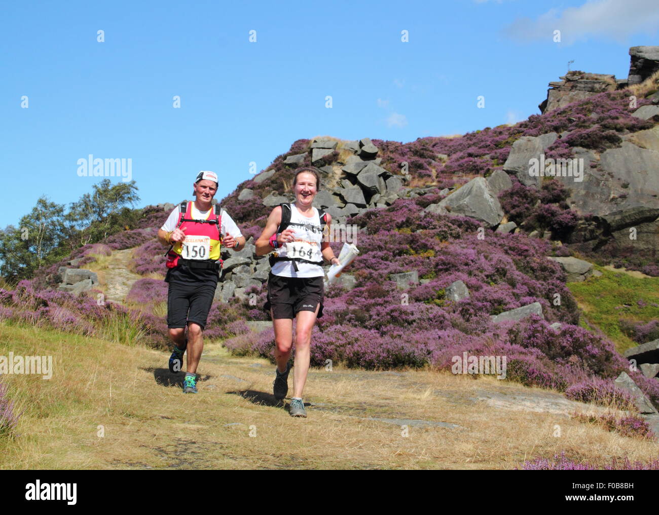 Fell runners traverse Burbage Moor near Sheffield in the PEak District National Park, England UK - summer Stock Photo