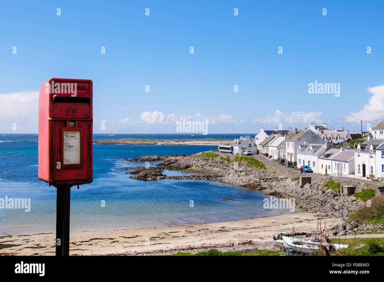 Red postbox outside Post Office on seafront in Portnahaven, Isle of Islay, Inner Hebrides, Western Isles, Scotland, UK, Britain Stock Photo