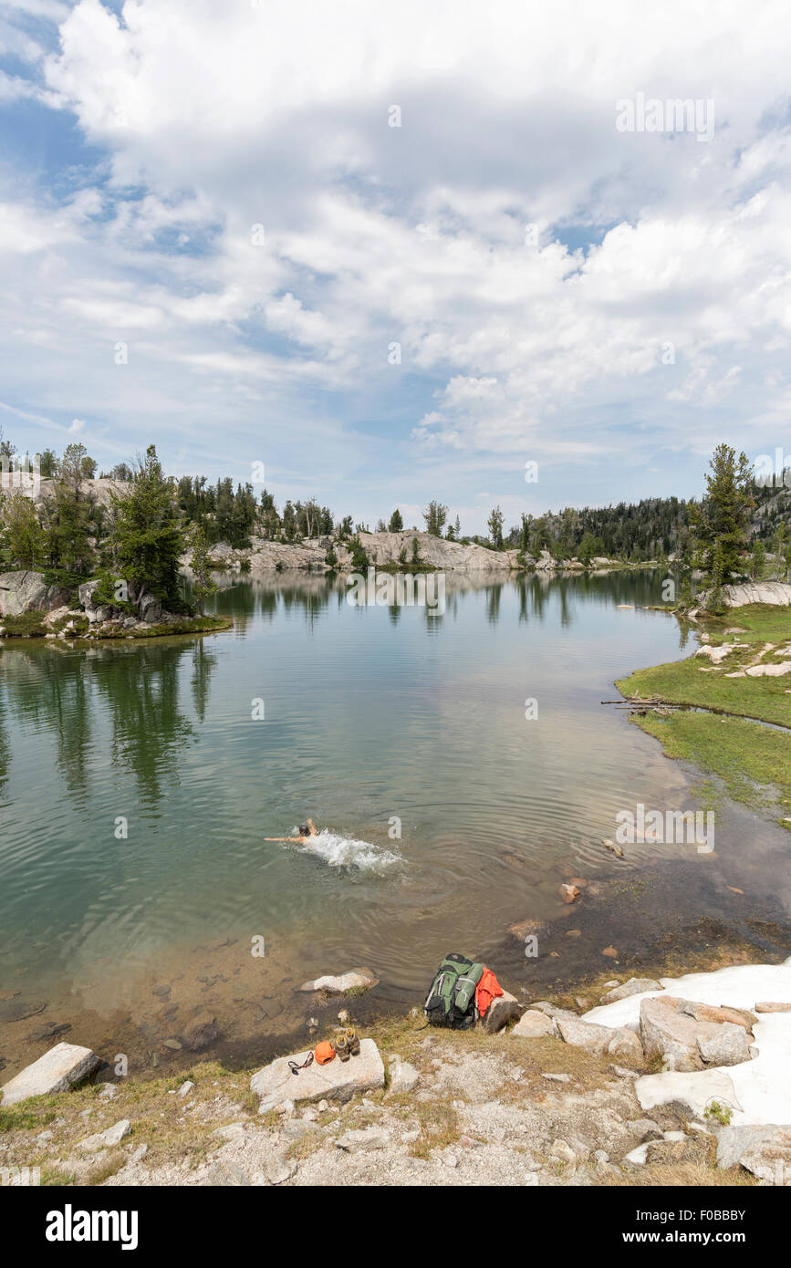 Backpacker diving into a lake high in Oregon's Wallowa Mountains. Stock Photo
