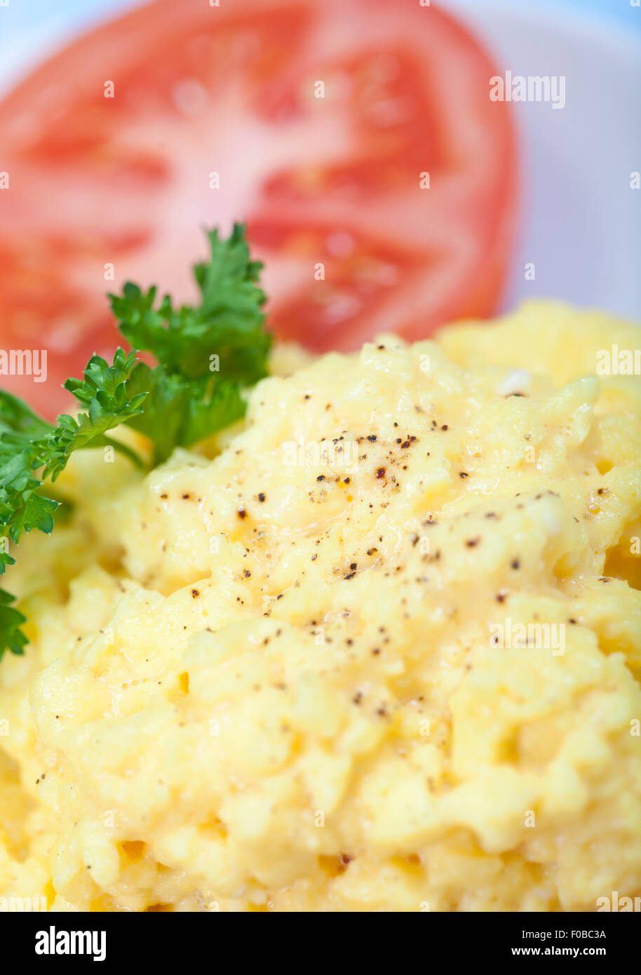 Scrambled eggs macro with a red tomato Stock Photo