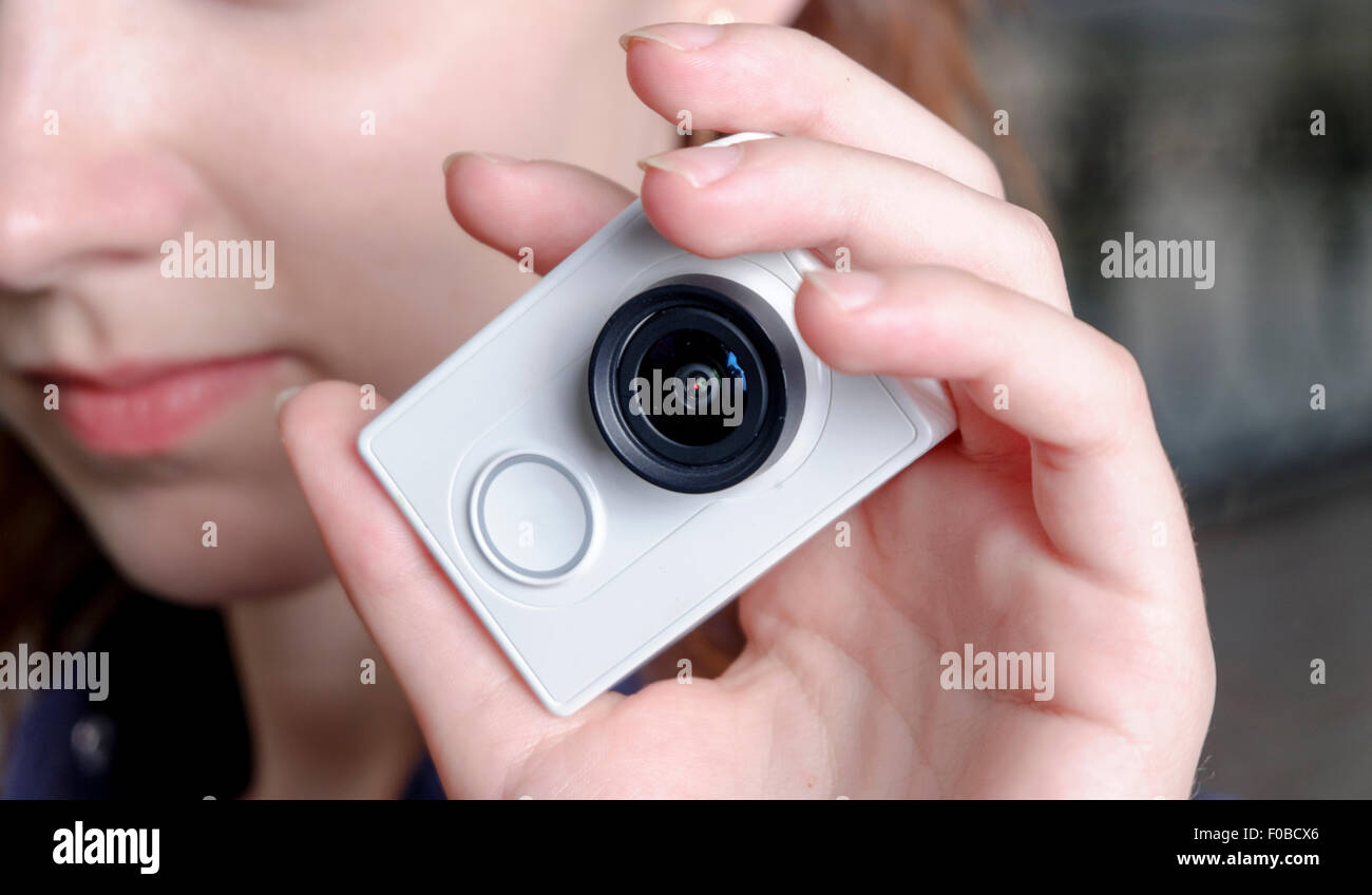 Young sporty women with unrecognisable action camera in hands Stock Photo