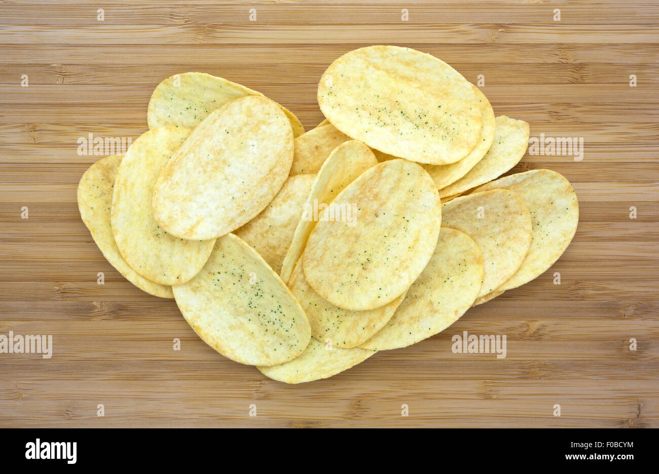 Top view of several sour cream and chive flavored potato chips on a