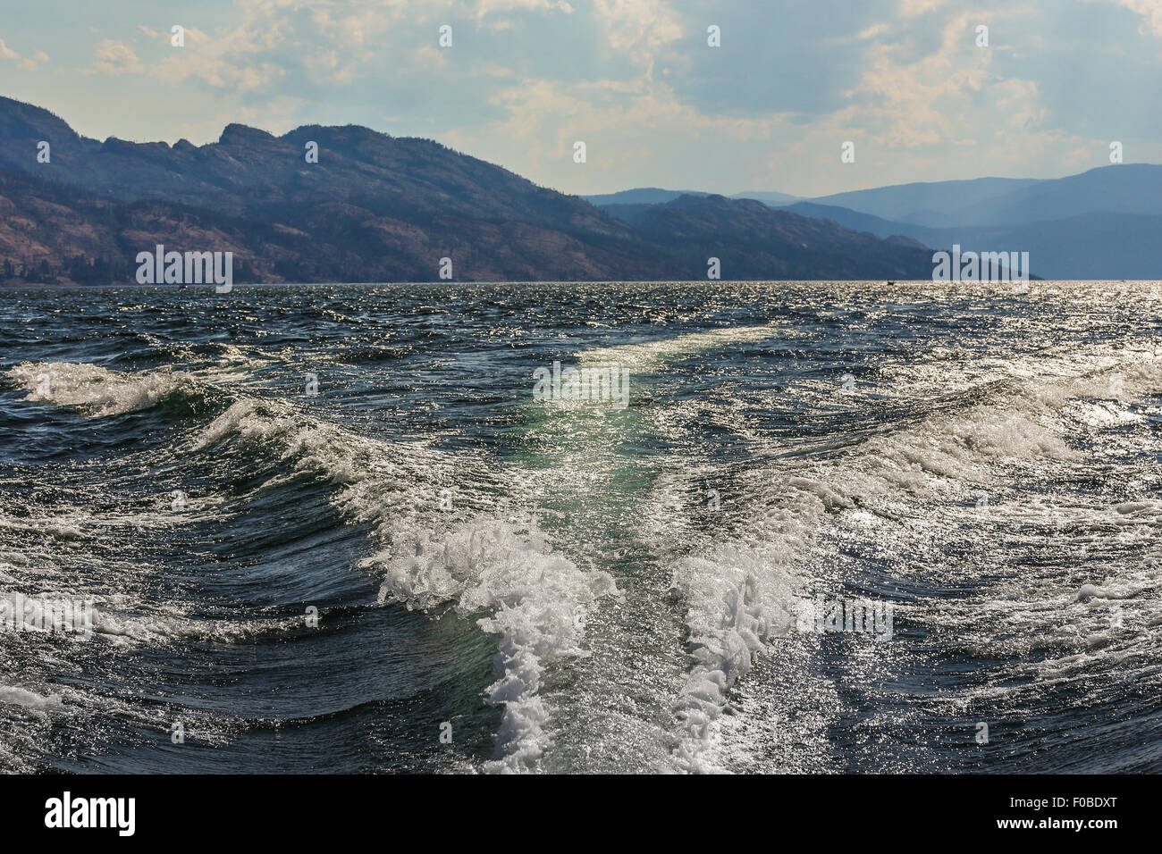 Okanagan Lake, Kelowna, Canada - taken from the back of a speed boat with the beautiful Okanagan valley in the background. Stock Photo