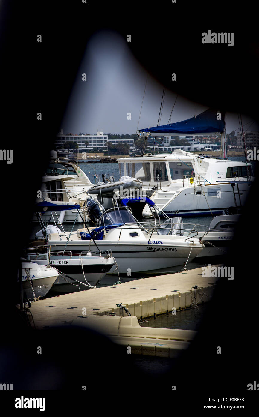 A framed view of yachts in Paphos Harbour, Cyprus. Stock Photo