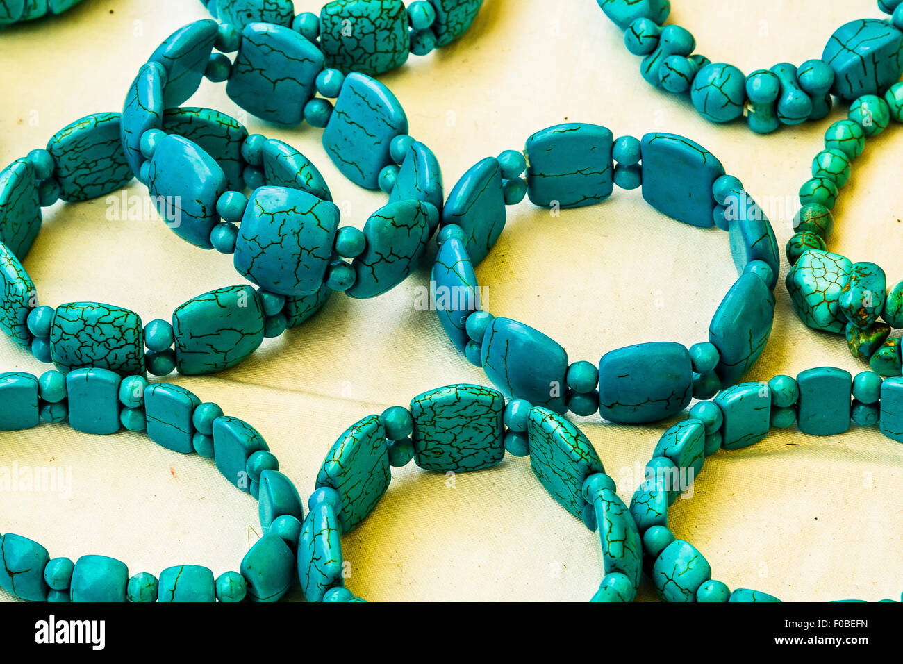Blue stone beads in bracelets on sale at a market stall Stock Photo