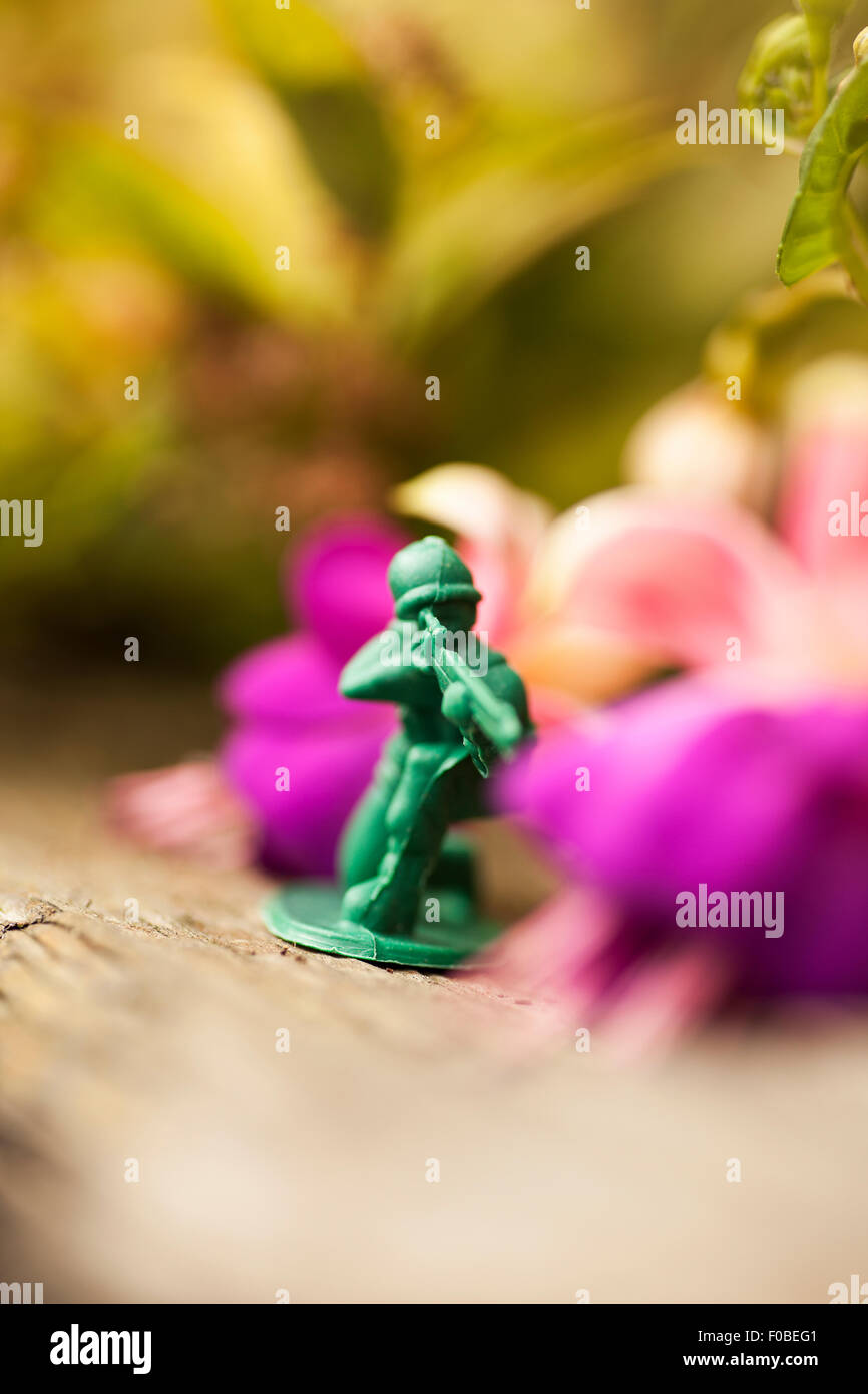 Green plastic toy soldiers/army men on a mission in the back garden
