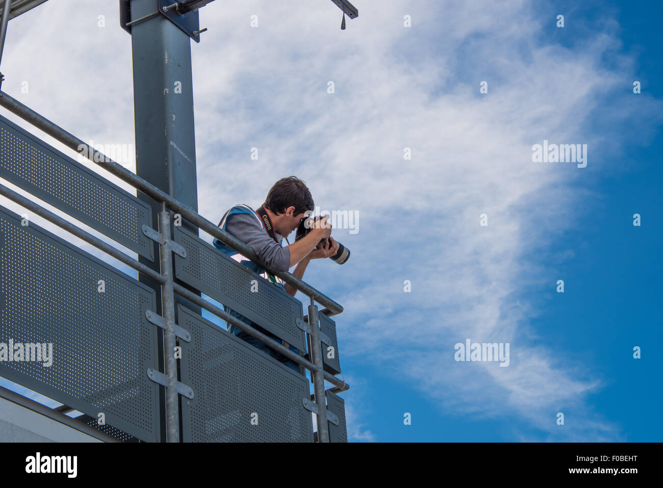 A member of Donington Park media team taking pictures in the pits during a break in testing at Donington Raceway Leicestershire Stock Photo