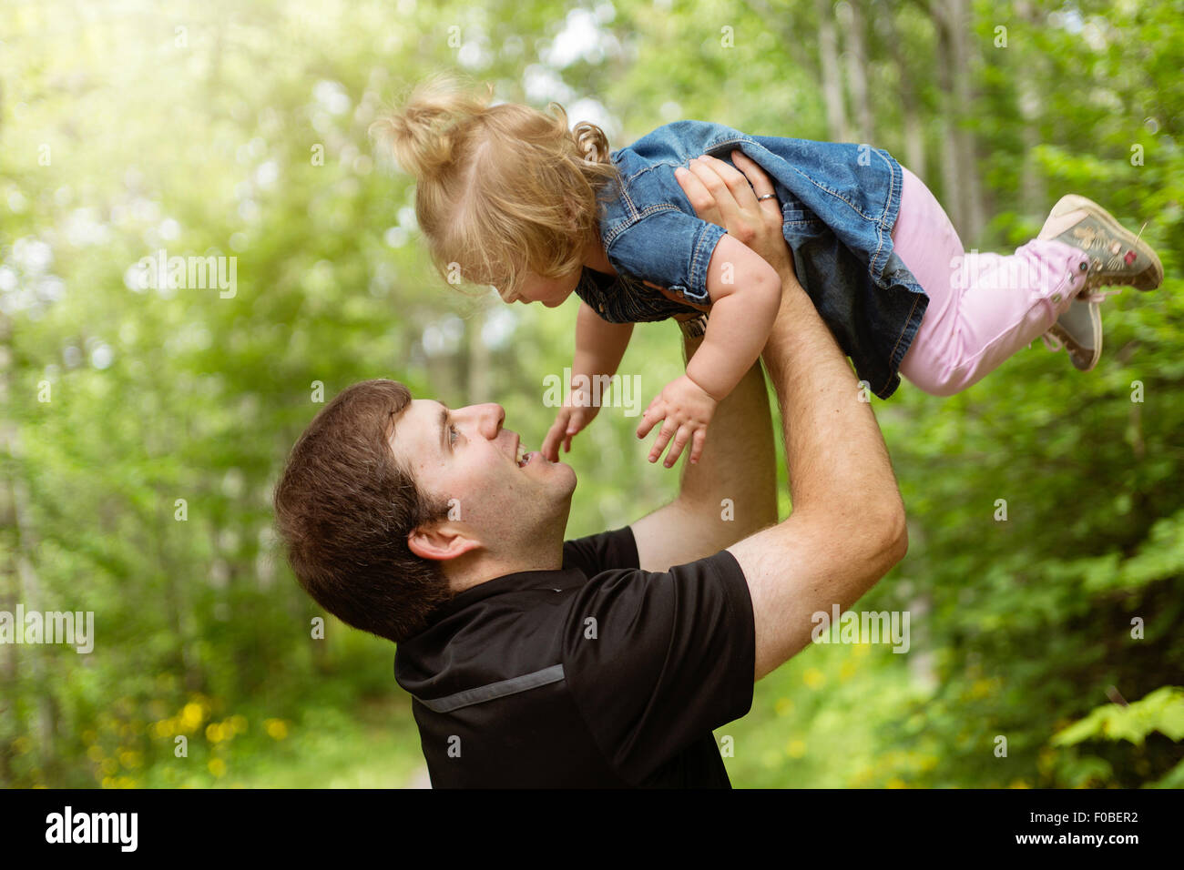 Father and daughter in forest on a meadow Stock Photo - Alamy