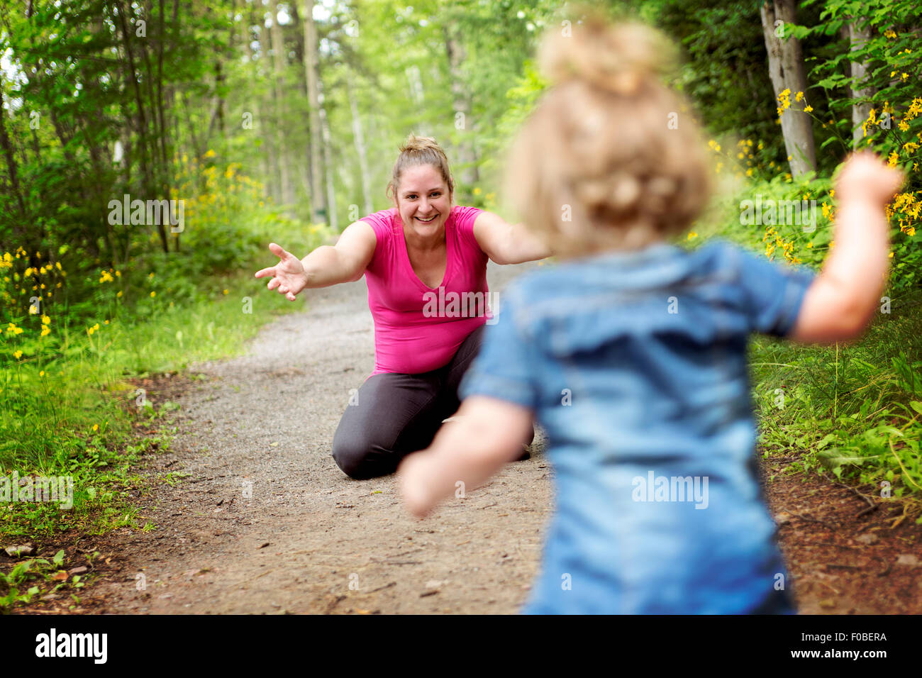 Mother and daughter in forest on a meadow Stock Photo