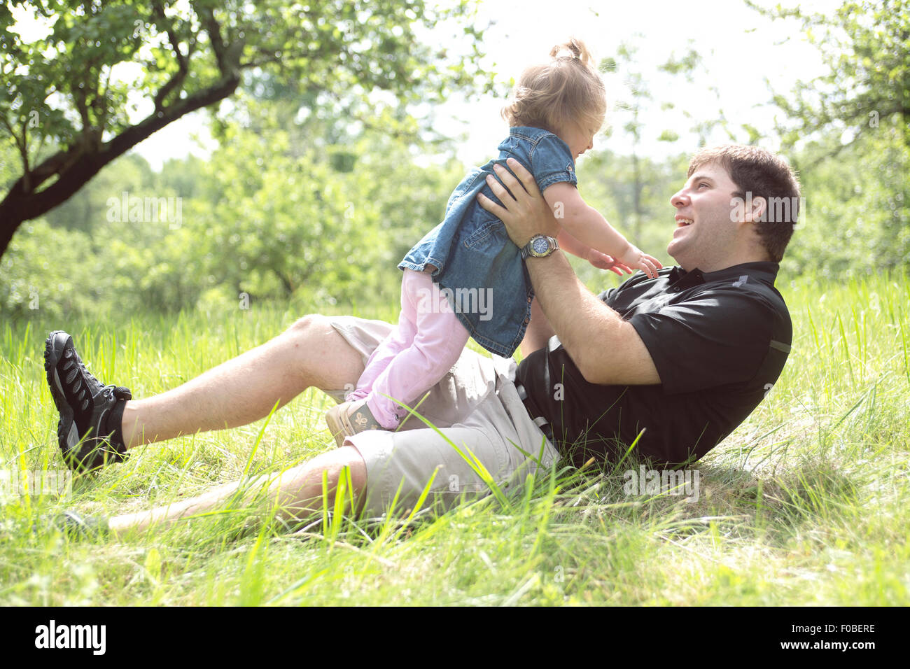 Father and daughter in forest on a meadow Stock Photo - Alamy