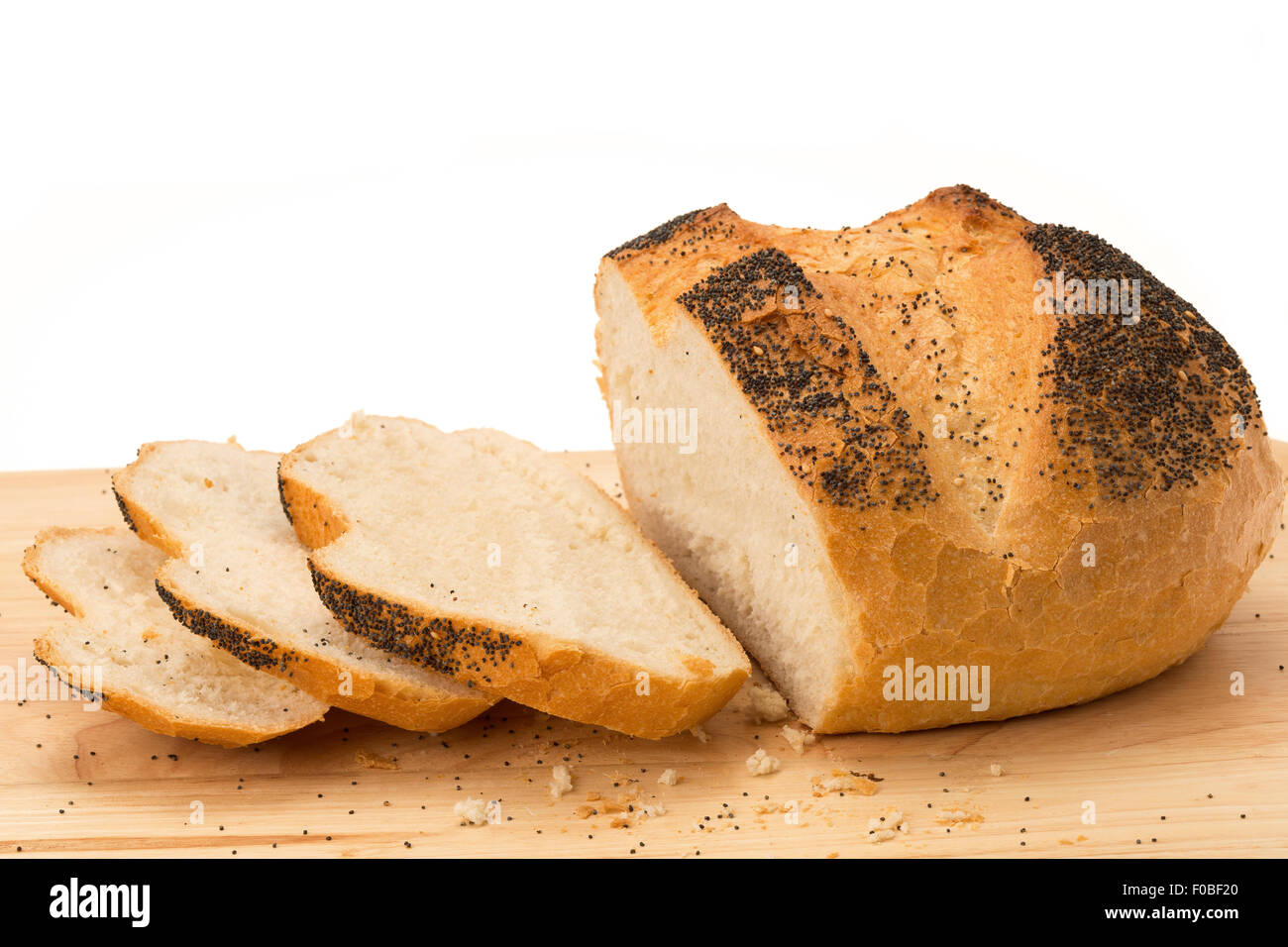 Fresh baked loaf of bread with slices on a wooden cutting board - white background Stock Photo