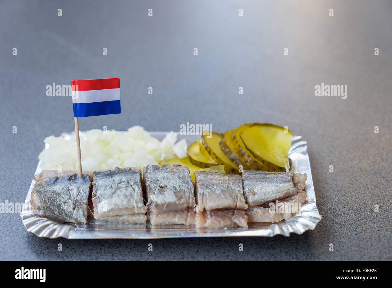 https://c8.alamy.com/comp/F0BF2K/a-dutch-herring-cut-up-into-slices-and-served-with-sliced-gherkin-F0BF2K.jpg