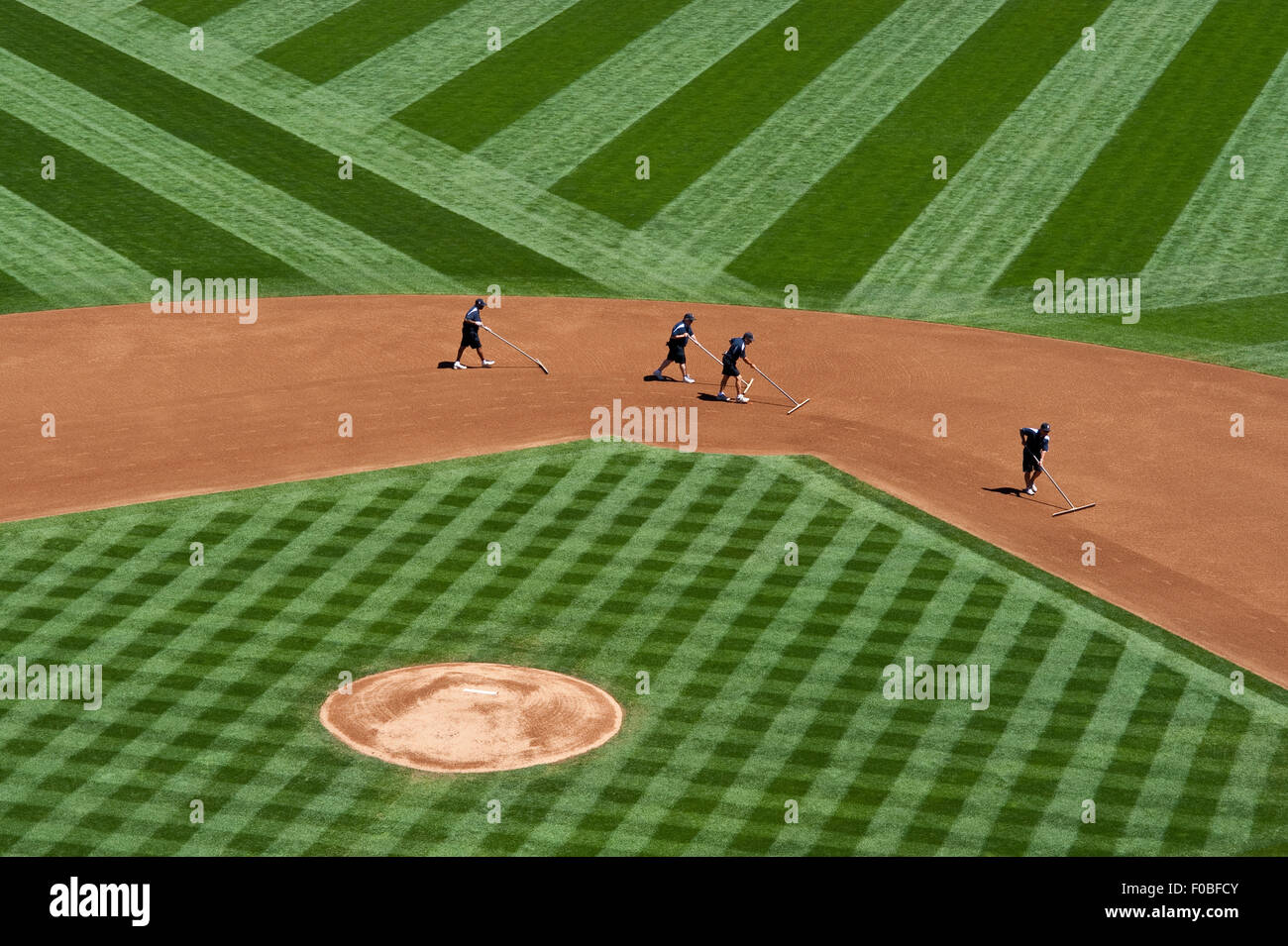 Baseball field abstract patterns with ground crew preparing the field