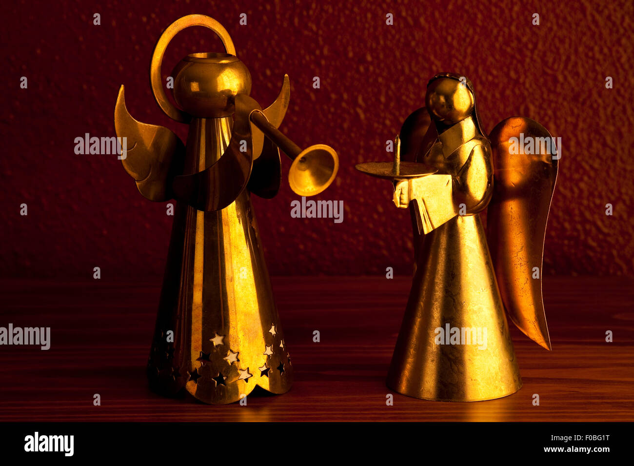 Bronze Metal angels playing music standing on desk candle holders Stock ...