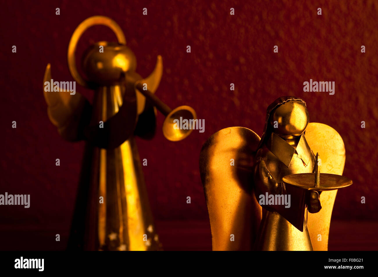 Bronze Metal angels playing music standing on desk candle holders Stock ...