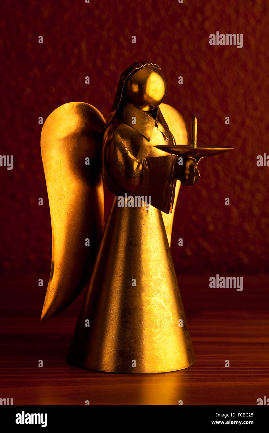 Bronze Metal angels playing music standing on desk candle holders Stock