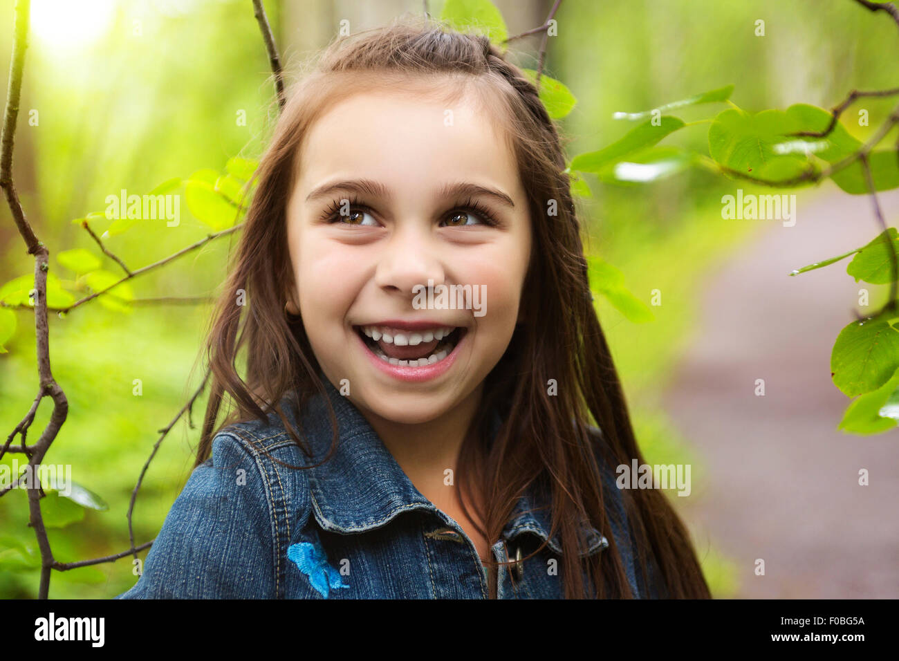 Adorable little girl in the forest meadow Stock Photo - Alamy