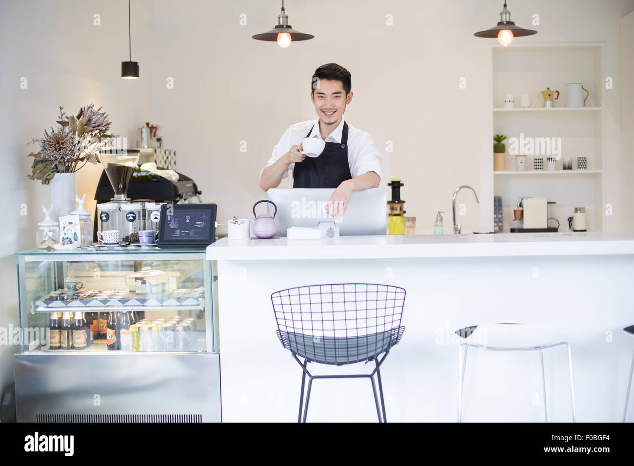 Coffee shop owner drinking coffee Stock Photo Alamy
