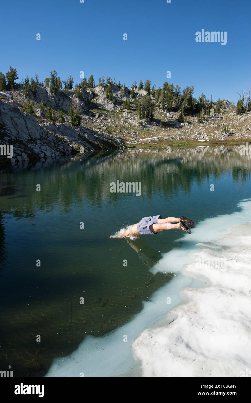 Hiker diving into Sky Lake, Wallowa Mountains, Oregon. Stock Photo