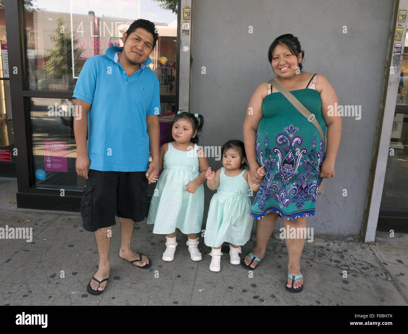 Mexican-American family in the Kensington section of Brooklyn, NY, 2015. The girls are (l. to r.) 3 and 2 y.o. Stock Photo