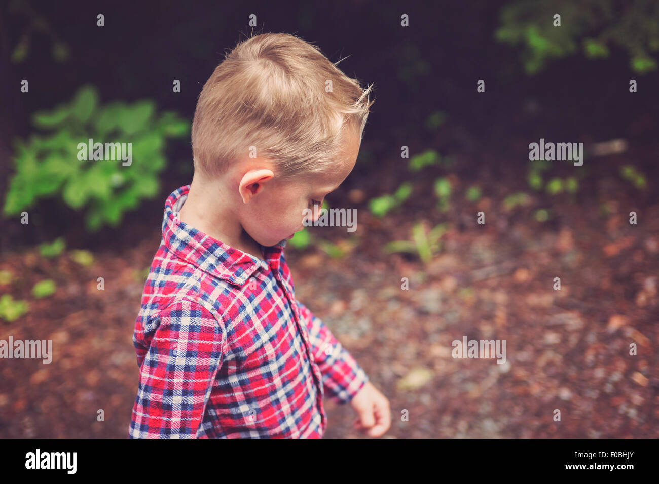 Side portrait of cute little boy child outdoors on the nature Stock Photo
