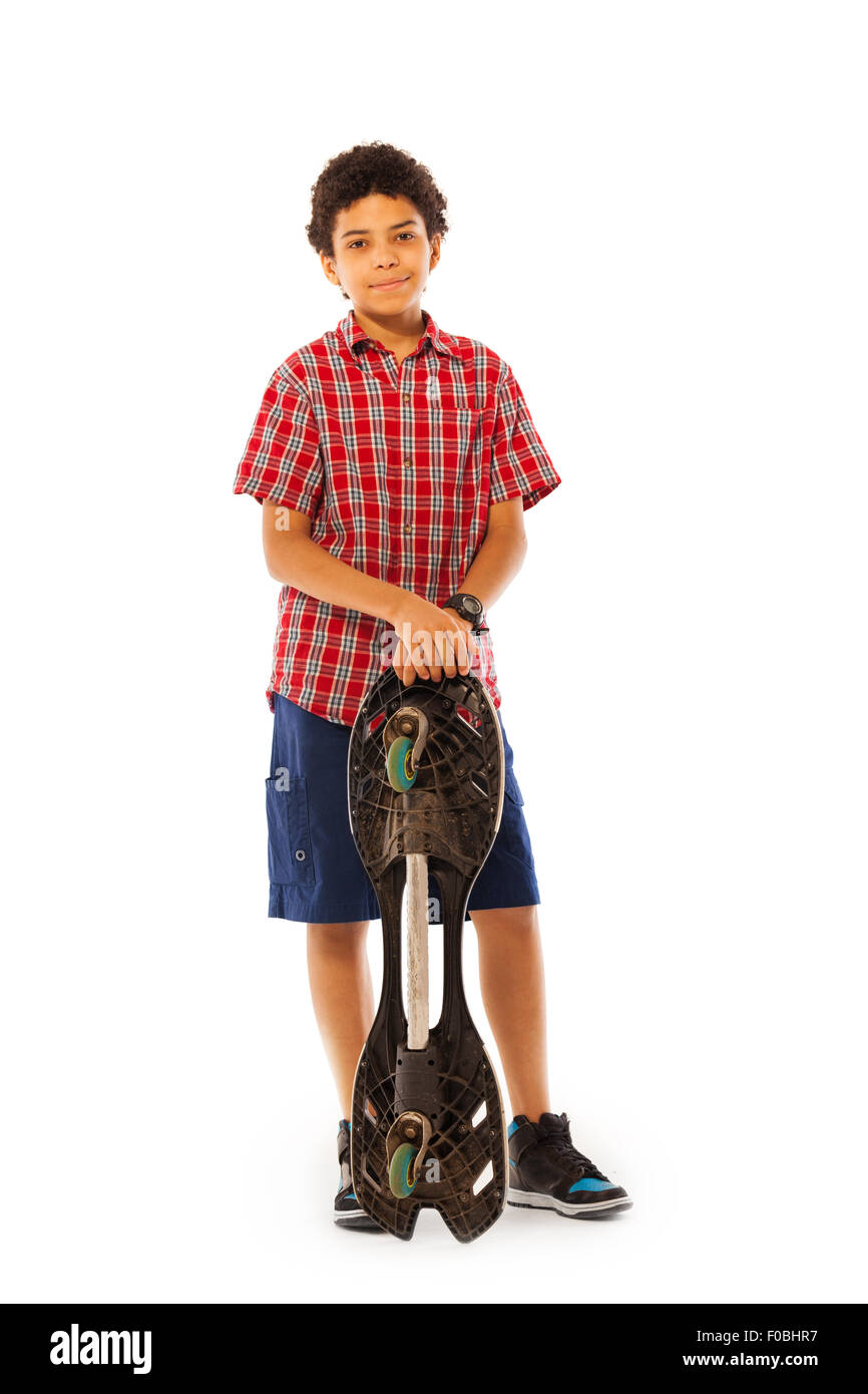 School age African boy standing with skate board Stock Photo