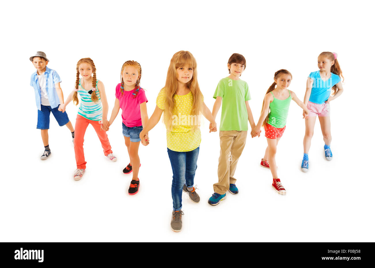 Many boys and girls stand together holding hands Stock Photo