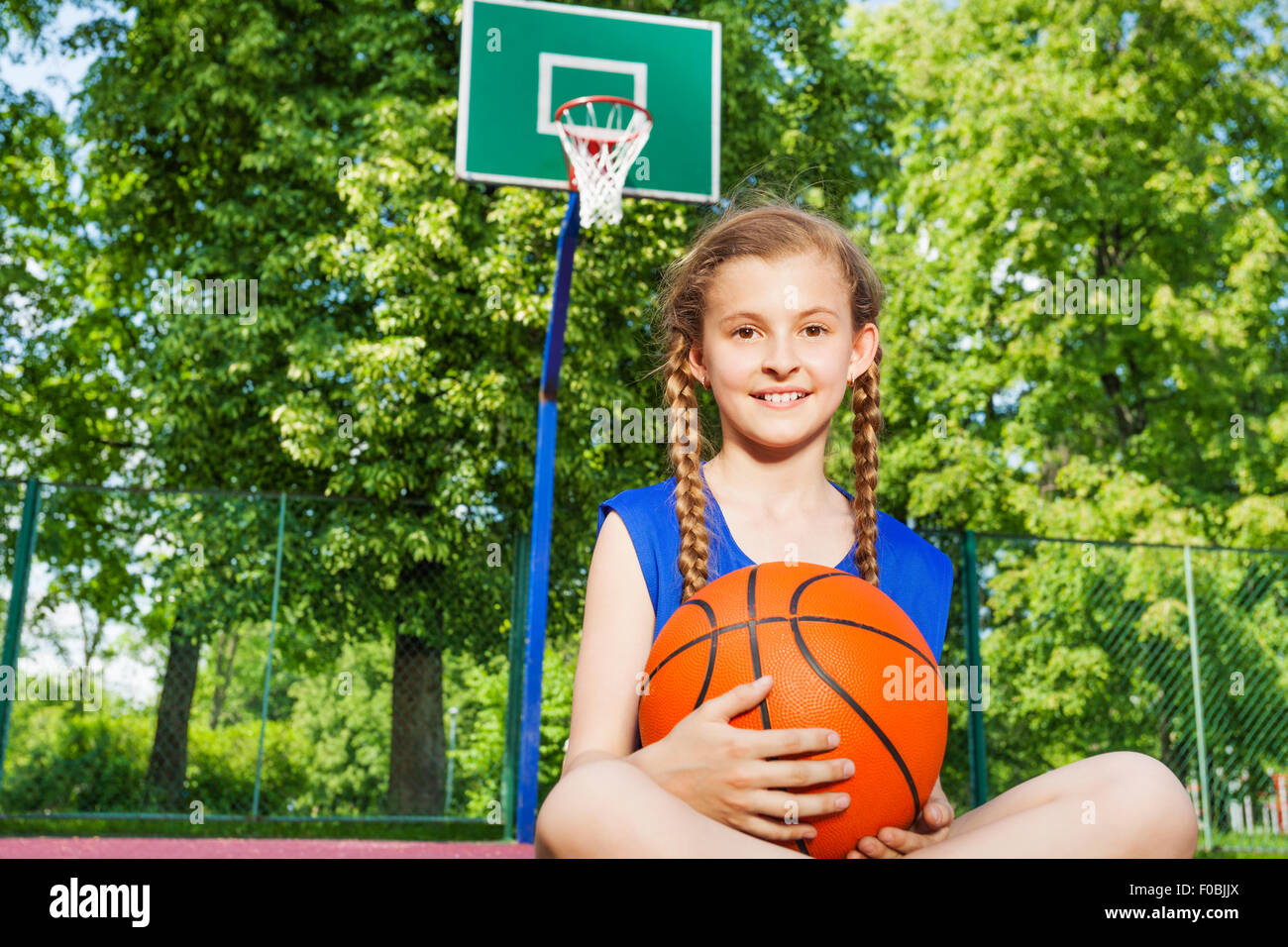 Teen girl sitting knees up hi-res stock photography and images - Alamy