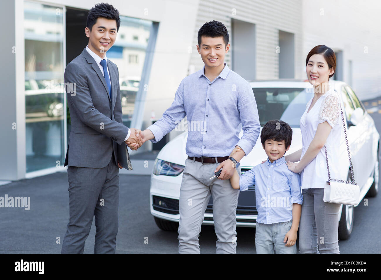 Young family buying car Stock Photo