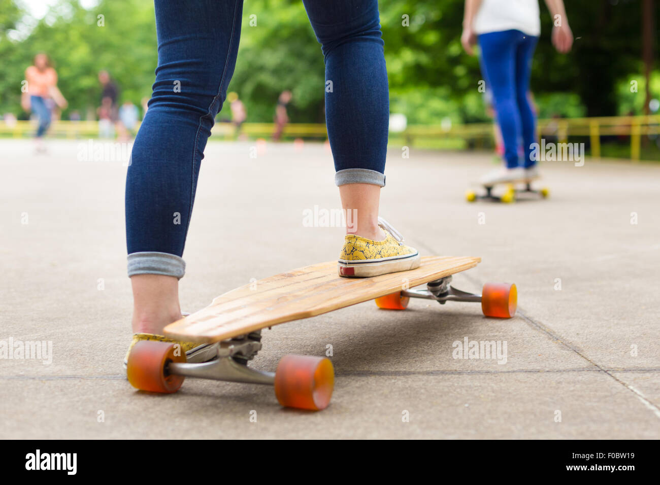 Teenage girl practicing riding long board Stock Photo - Alamy