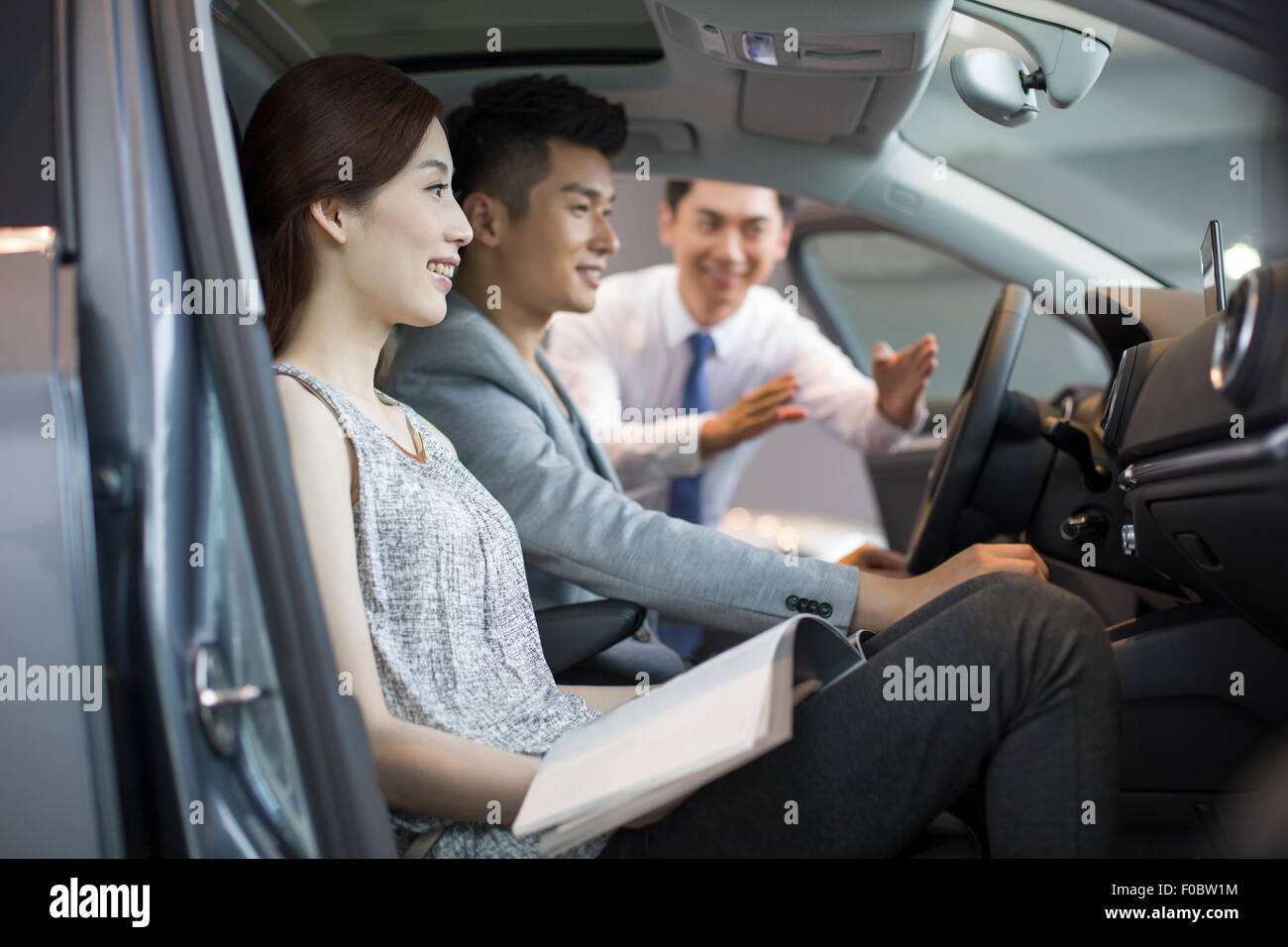 Young couple choosing car in showroom Stock Photo