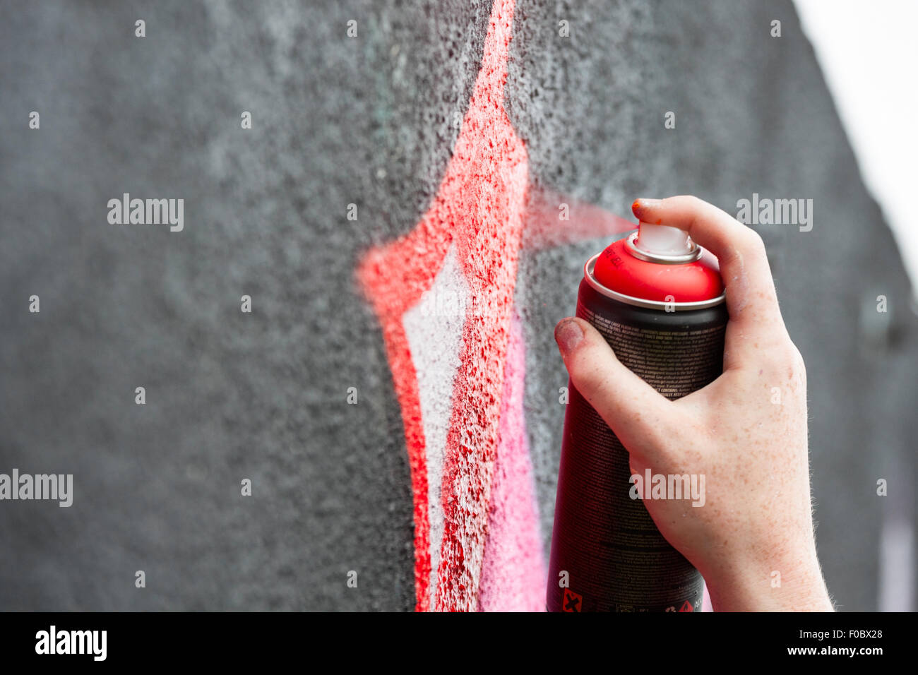 Graffity painter drawing a picture on the wall, detail Stock Photo