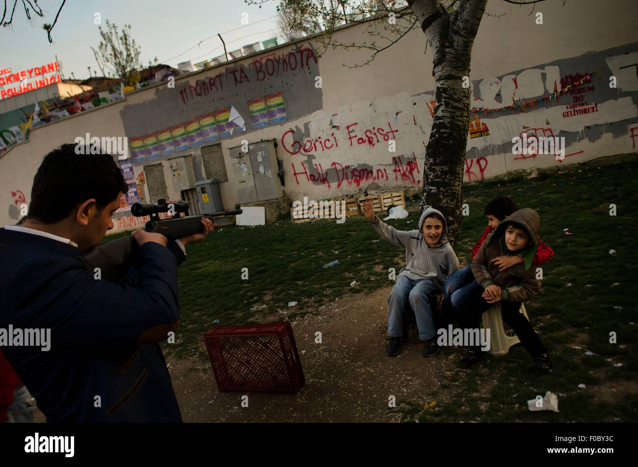 Shooting bottles in a park in Istanbul neighborhood of Okmaydani-walls covered in anti (government) AkP slogans Stock Photo