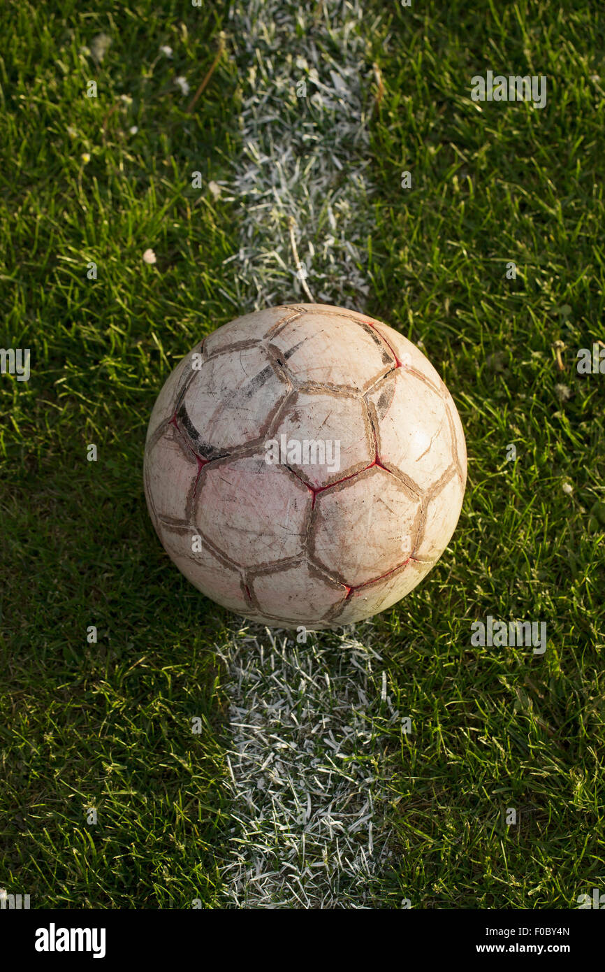 Close-up of soccer ball on white line in stadium Stock Photo