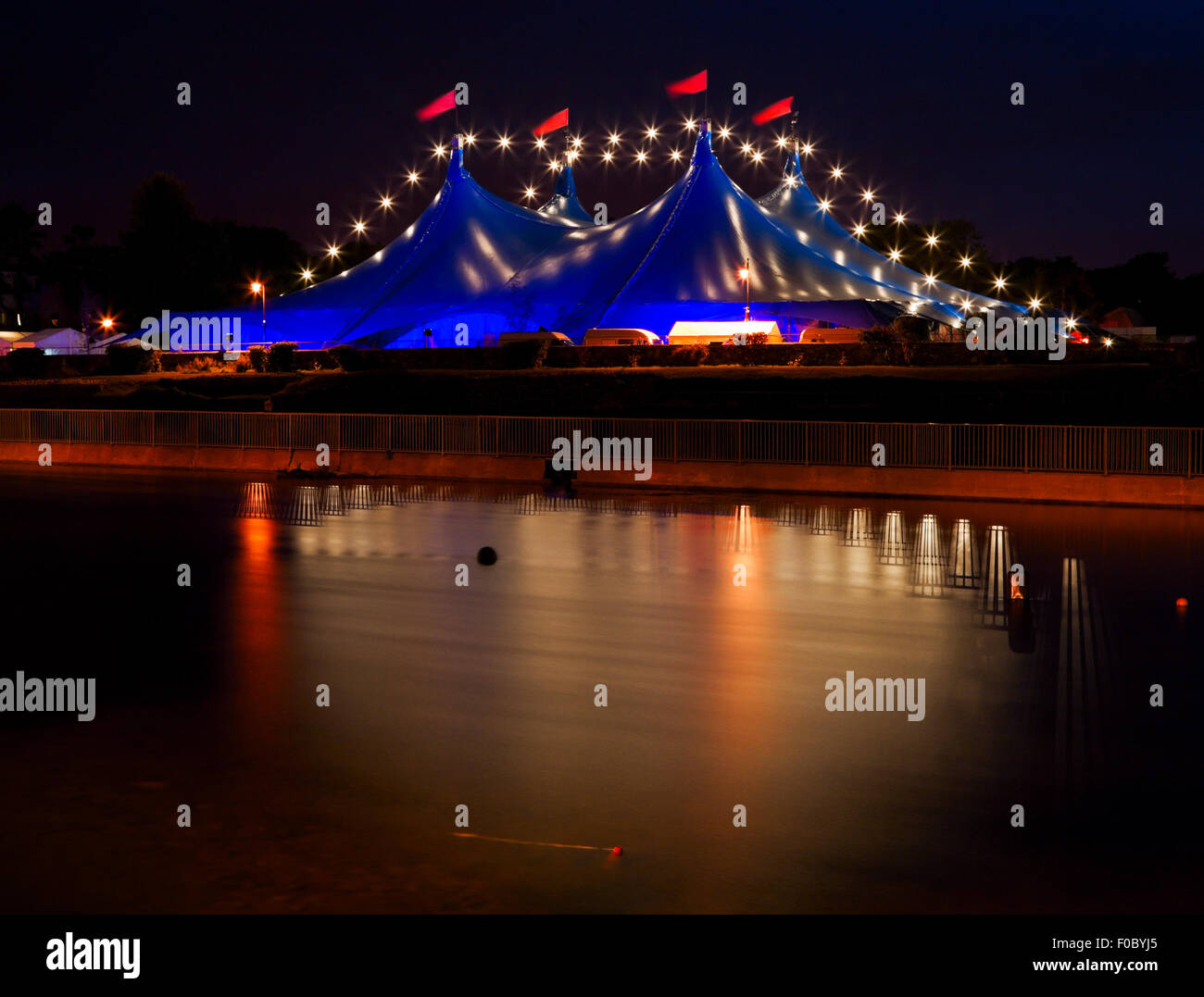 'Big Top' circus style blue tent and row of lights on the bank of Corrib river in Galway, Ireland Stock Photo