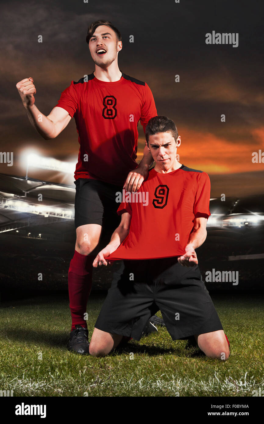 Young soccer players celebrating on field Stock Photo