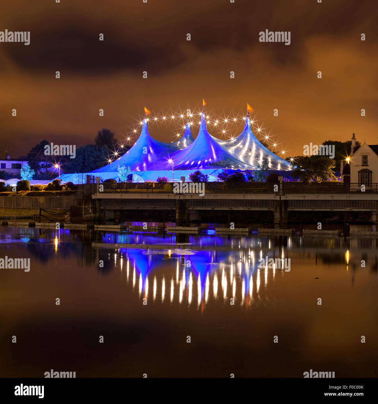 'Big Top' circus style blue tent and row of lights on the bank of Corrib river in Galway, Ireland Stock Photo