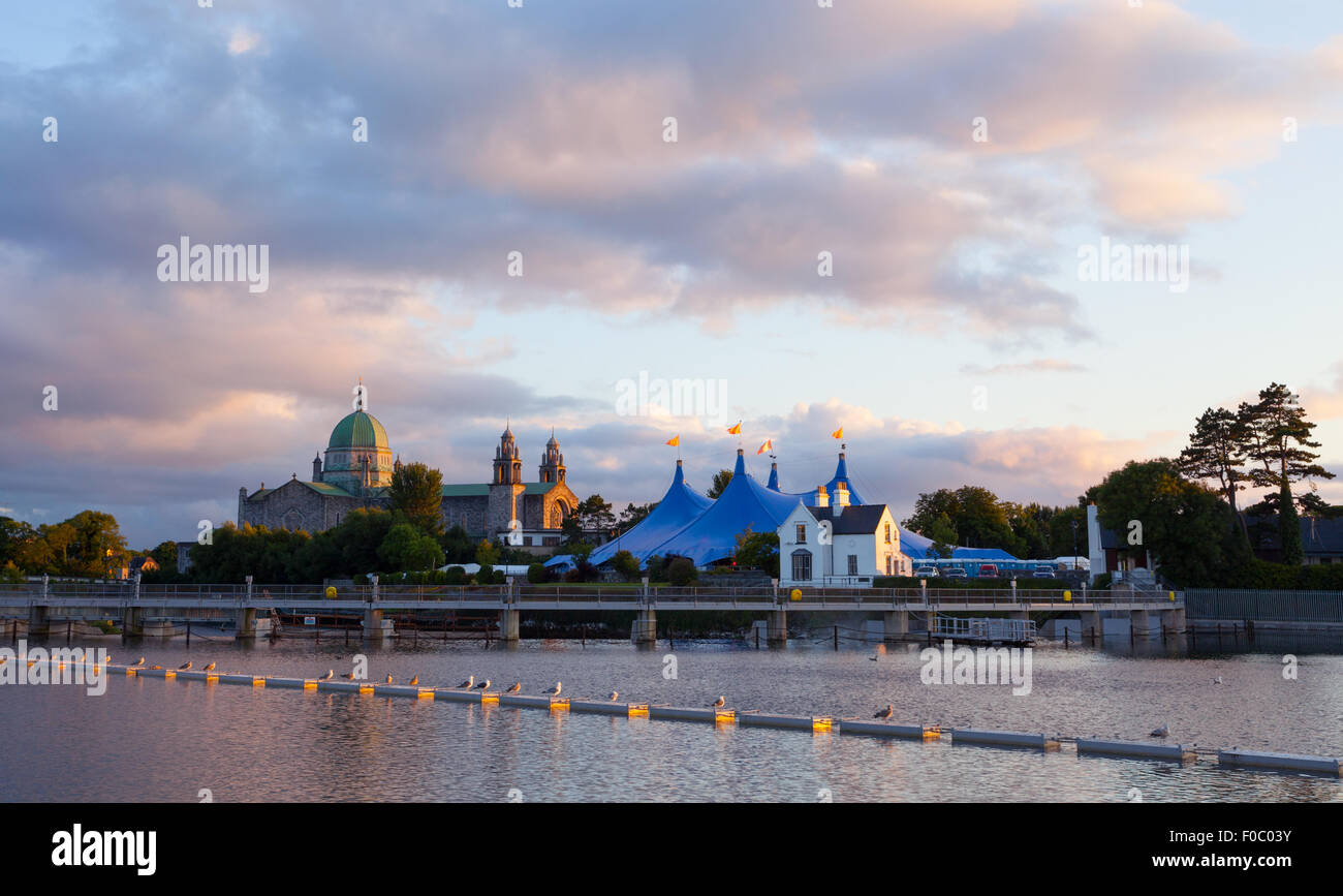 'Big Top' circus style blue tent and Galway Cathedral on the bank of Corrib river in Galway, Ireland Stock Photo