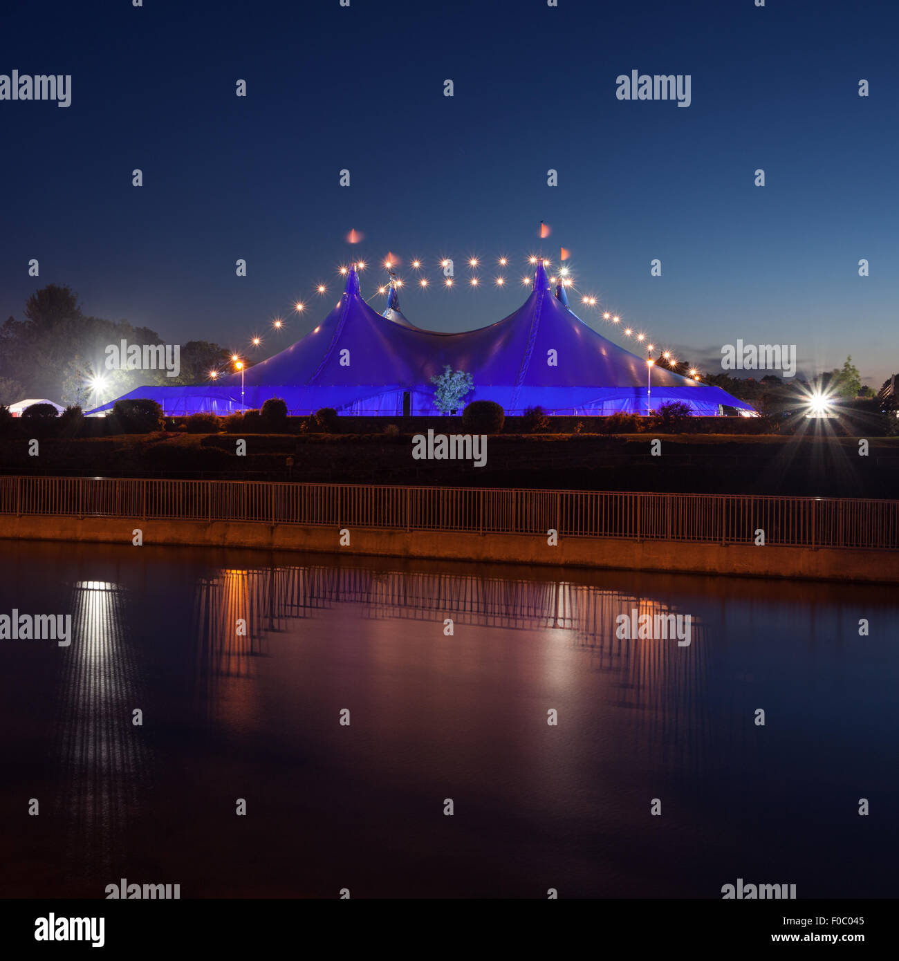 'Big Top' circus style blue tent and Galway Cathedral on the bank of Corrib river in Galway, Ireland Stock Photo