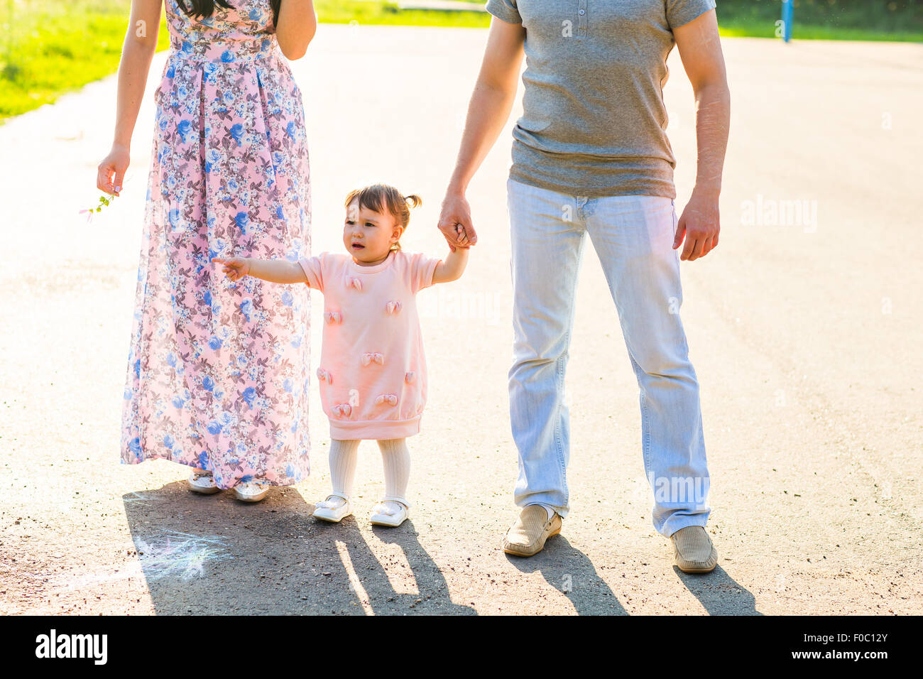 Happy Young Family Walking In The Park Stock Photo - Alamy