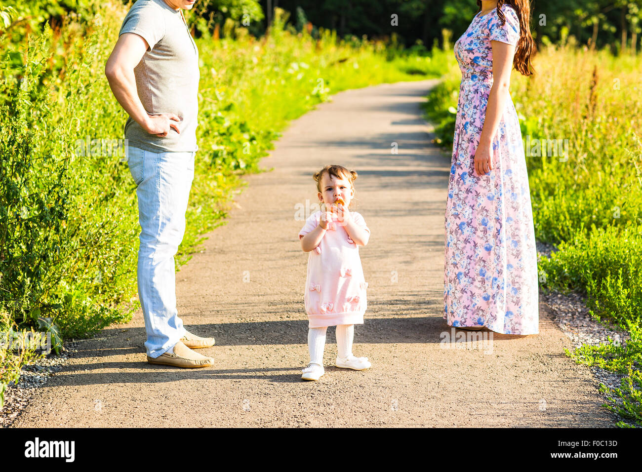 Happy Young Family Walking In The Park Stock Photo - Alamy