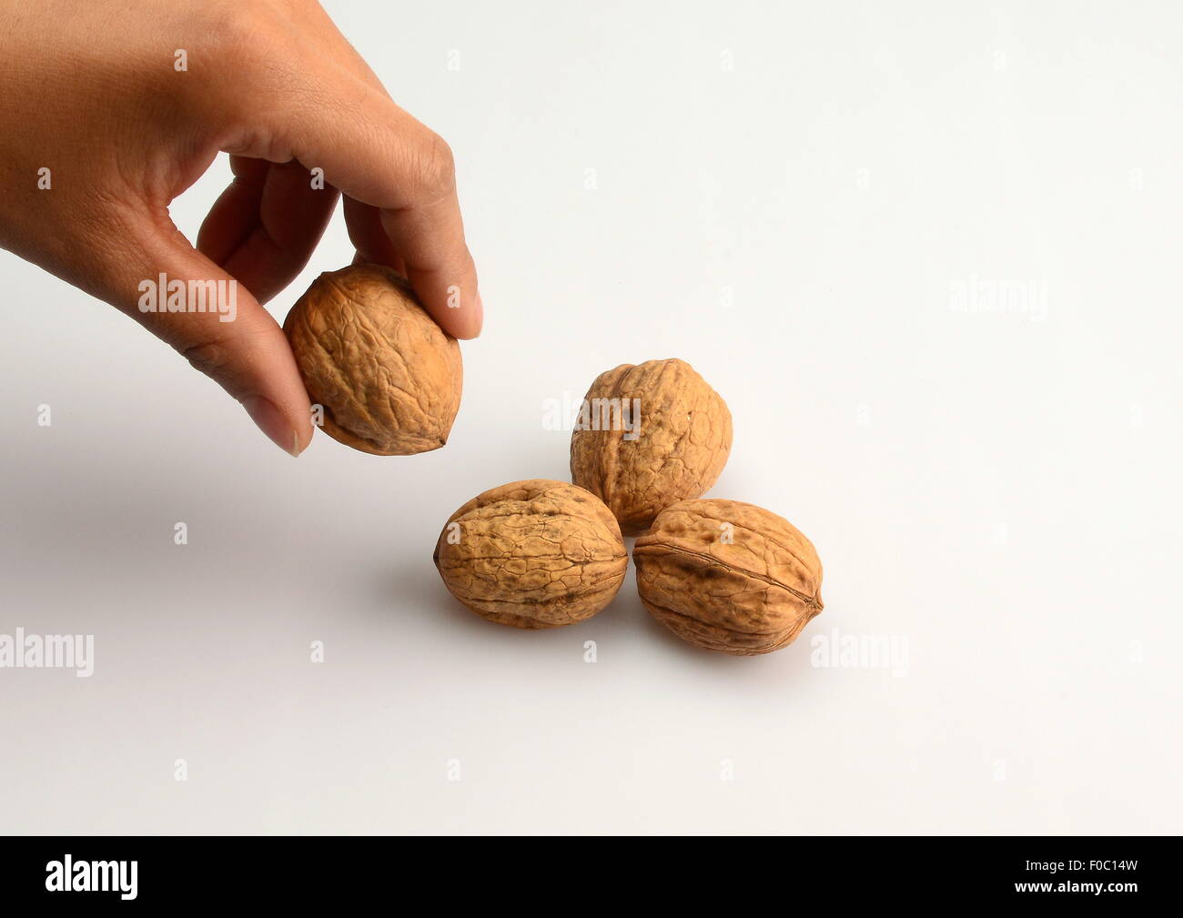 leisure / hobby / sports, game, nut pyramid, adding of fourth walnut as top of the pyramid, Additional-Rights-Clearance-Info-Not-Available Stock Photo