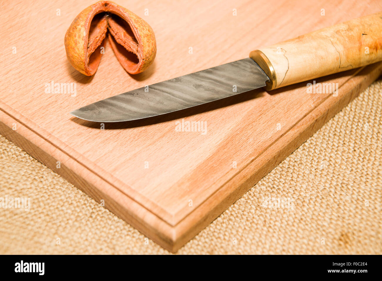 Honed is a hunting knife on a wooden surface Stock Photo