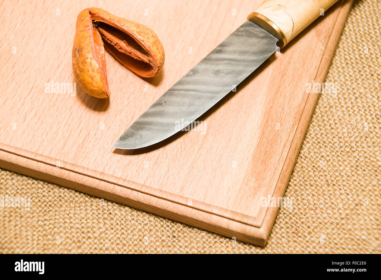 Honed is a hunting knife on a wooden surface Stock Photo