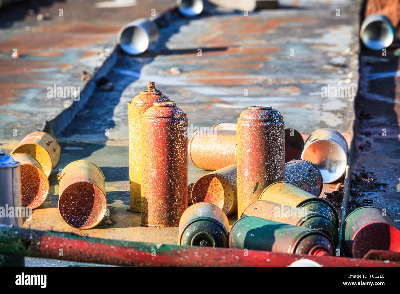 Used graffiti spray cans laying around Stock Photo - Alamy