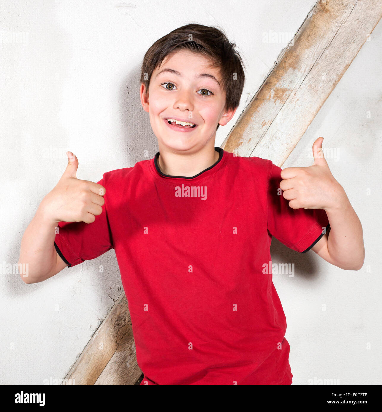 Portrait of a young boy with his thumbs up Stock Photo - Alamy
