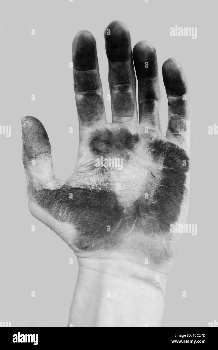 Close-up of dirty hand over gray background Stock Photo